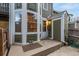 View of the backyard patio with green painted siding and windows of the home at 18577 E Whitaker Cir # C, Aurora, CO 80015