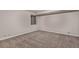 Empty basement area with carpet flooring and small window, ready to be customized at 18577 E Whitaker Cir # C, Aurora, CO 80015