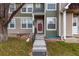 Charming townhouse showcasing the entrance, stairs, and a combination of siding colors at 18577 E Whitaker Cir # C, Aurora, CO 80015