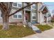 Inviting townhouse exterior with well-maintained lawn and a charming entryway staircase at 18577 E Whitaker Cir # C, Aurora, CO 80015