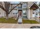 Townhouse exterior featuring a well-kept lawn, concrete steps, and charming siding at 18577 E Whitaker Cir # C, Aurora, CO 80015