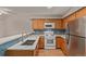 Well-lit kitchen features stainless steel appliances, and tile backsplash at 18577 E Whitaker Cir # C, Aurora, CO 80015