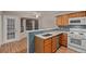 Kitchen with breakfast bar, stainless steel appliances and tile backsplash at 18577 E Whitaker Cir # C, Aurora, CO 80015