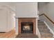 Living room view of fireplace with logs and stairway at 18577 E Whitaker Cir # C, Aurora, CO 80015