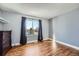 Bright bedroom with wood floors and a large window at 2808 S Fundy St, Aurora, CO 80013