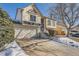 Two-story house with a double car garage and snow-covered driveway at 2808 S Fundy St, Aurora, CO 80013