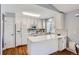 White kitchen with a breakfast bar and a view into the dining area at 2808 S Fundy St, Aurora, CO 80013