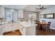 White kitchen with a breakfast bar, subway tile backsplash and a view into dining area at 2808 S Fundy St, Aurora, CO 80013