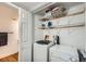 Basement laundry room with washer, dryer, and storage shelves at 2808 S Fundy St, Aurora, CO 80013