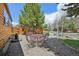 Outdoor patio with metal table and chairs set in a gravel landscape; wooden log cabin home at 85 Revett Dr # 40, Breckenridge, CO 80424