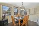 Sunlit dining room features a wooden table, chandelier lighting, and scenic views from multiple windows at 85 Revett Dr # 40, Breckenridge, CO 80424