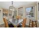 Bright dining room with a wooden table, chandelier, and multiple windows offering scenic views at 85 Revett Dr # 40, Breckenridge, CO 80424
