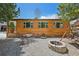 Exterior view of log cabin with gravel landscape, swing set, and fire pit at 85 Revett Dr # 40, Breckenridge, CO 80424