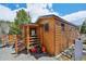 Cozy log cabin with a small porch, offering a rustic retreat amidst a natural landscape at 85 Revett Dr # 40, Breckenridge, CO 80424