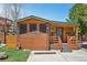 Charming log cabin with covered porch, stone accents, and a well-maintained lawn at 85 Revett Dr # 40, Breckenridge, CO 80424