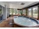 Inviting indoor hot tub room with wood floors, stone accents, and scenic mountain views through large windows at 85 Revett Dr # 40, Breckenridge, CO 80424