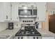 Close up of the stovetop showing the granite countertops and stainless steel appliances at 85 Revett Dr # 40, Breckenridge, CO 80424