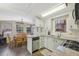 Well-lit kitchen featuring granite countertops, white cabinets, and seamless flow into the dining area at 85 Revett Dr # 40, Breckenridge, CO 80424