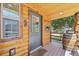 Charming covered porch with a rustic barrel accent and a view of the serene neighborhood at 85 Revett Dr # 40, Breckenridge, CO 80424