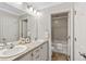 Bright bathroom features double sinks, white cabinets, and a separate toilet and tub area at 7422 E 7Th Ave # 14, Denver, CO 80230