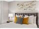 Cozy bedroom featuring a tufted headboard, stylish accent pillows, and ample natural light at 7422 E 7Th Ave # 14, Denver, CO 80230