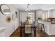 Dining room with dark wood floors, contemporary decor, and seamless connection to the kitchen at 7422 E 7Th Ave # 14, Denver, CO 80230