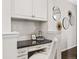 Built-in home office area with granite countertop, storage cabinets, drawers, and decorative mirror wall decor at 7422 E 7Th Ave # 14, Denver, CO 80230