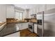 Modern kitchen boasts granite countertops, stainless steel appliances, and bright white cabinetry at 7422 E 7Th Ave # 14, Denver, CO 80230