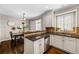 Elegant kitchen with dark granite countertops, stainless steel appliances, and a seamless transition to the dining area at 7422 E 7Th Ave # 14, Denver, CO 80230