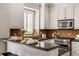 Stylish kitchen features granite counters, stainless steel appliances, and a convenient breakfast bar at 7422 E 7Th Ave # 14, Denver, CO 80230