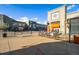 Street view of a town center featuring stores, restaurants, and outdoor seating under a bright, blue sky at 7422 E 7Th Ave # 14, Denver, CO 80230