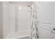 Clean bathroom featuring a shower with white tile, decorative accent tile, and a shower curtain at 11898 Discovery Cir, Parker, CO 80138