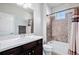 Clean bathroom with shower/tub combo and dark cabinets at 11898 Discovery Cir, Parker, CO 80138