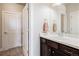 Well-lit bathroom features a dark wood vanity, white countertops, a decorative towel and tile floor at 11898 Discovery Cir, Parker, CO 80138