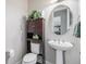 Powder room with pedestal sink and dark wood cabinet at 11898 Discovery Cir, Parker, CO 80138