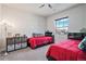 Shared bedroom featuring two twin beds, plush carpet, a ceiling fan, and a large window at 11898 Discovery Cir, Parker, CO 80138