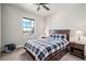 Bright bedroom features plush carpet, a large window, and a dark wood bed frame with drawer storage at 11898 Discovery Cir, Parker, CO 80138