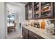 Butlers pantry with glass-front cabinets and granite countertops at 11898 Discovery Cir, Parker, CO 80138