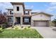 Charming two-story home featuring stone accents, a well-manicured lawn, and an attached two-car garage at 11898 Discovery Cir, Parker, CO 80138
