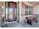 Front entrance with stonework, a wooden bench, and a burgundy door at 11898 Discovery Cir, Parker, CO 80138