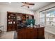 Home office with built-in shelving and large window at 11898 Discovery Cir, Parker, CO 80138