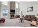 Spacious living room with a stone fireplace and leather furniture at 11898 Discovery Cir, Parker, CO 80138