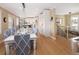 Elegant dining area with a large table, modern light fixture, and kitchen views at 7107 E Costilla Dr, Centennial, CO 80112