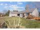 Charming single-story home featuring a well-manicured lawn, gray siding, and a gray tile roof under a blue sky at 7107 E Costilla Dr, Centennial, CO 80112