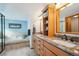 Bright bathroom featuring double sinks, granite countertops, and a separate tub at 9839 Foxhill Cir, Highlands Ranch, CO 80129