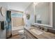 Cozy bathroom featuring a single sink, granite countertops, and a shower-tub combination at 9839 Foxhill Cir, Highlands Ranch, CO 80129