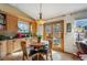 Cozy dining area with hardwood floors, a round table, and direct access to the backyard via sliding glass doors at 9839 Foxhill Cir, Highlands Ranch, CO 80129