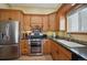 Updated kitchen with stainless steel appliances, hardwood floors, plenty of counter space, and natural lighting from a window at 9839 Foxhill Cir, Highlands Ranch, CO 80129