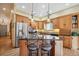 Modern kitchen with stainless steel appliances, a center island with seating, and ample cabinet space with a breakfast nook at 9839 Foxhill Cir, Highlands Ranch, CO 80129