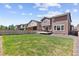 A large, grassy backyard featuring a patio and wooden fence for privacy at 13221 E 110Th Pl, Commerce City, CO 80022